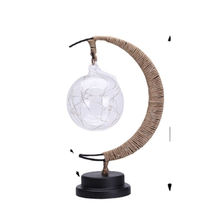 Creative LED crescent moon lamp with twine wrapping and glass globe on white background