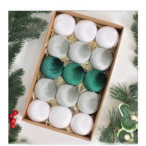 Detailed view of 15 green velvet Christmas balls set in elegant gift packaging