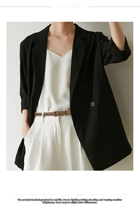 Brown leather belt with pin buckle styled on dress pants for a trendy chic office look