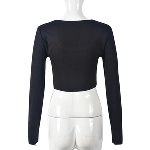 Rear view of black cropped long sleeve top in ribbed knit fabric on a white mannequin