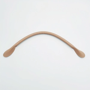 Detailed view of camel leather handbag straps featuring pre-punched stitching holes