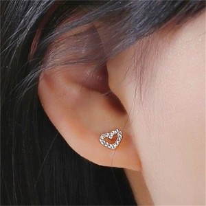 Close-up of S925 sterling silver heart stud earrings with pavé white zircon settings