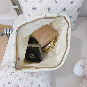 Close-up of quilted floral cosmetic bag with large capacity and smooth zipper closure