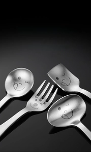 Macro shot of 304 stainless steel cutlery featuring smiley faces and brushed finish texture