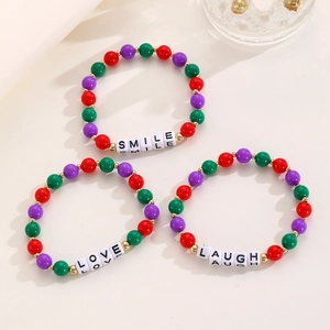 Detail of colorful beaded bracelets with SMILE, LOVE, and LAUGH acrylic letter beads