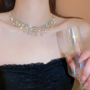 Close-up of sparkling silver zircon tassel necklace on model for luxury formal look
