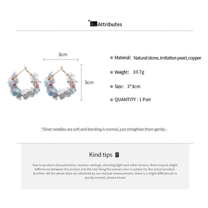 Detailed specs of silver needle hoop earrings with natural stones and pearls