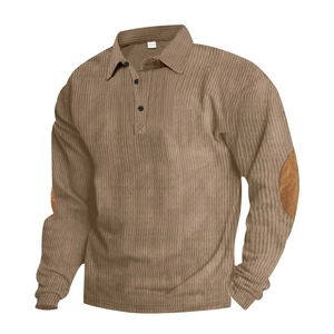 Detail of brown corduroy polo shirt featuring vintage elbow patches and ribbed cuffs