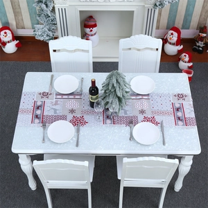 Close-up of Christmas table runner with reindeer and snowflake prints on a festive table