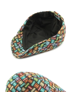 Detailed close-up of multi-color woven fabric texture and breathable inner lining on cap