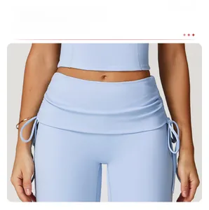 Detailed view of high waisted yoga pants with a fold-over waistband and side drawstring details