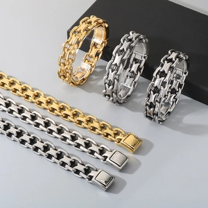 Detail of interlocking chunky Cuban chains in gold, silver, and antique silver finish