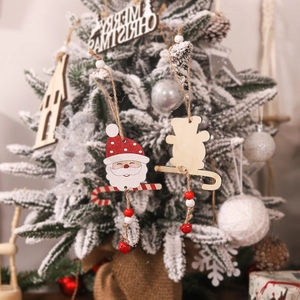 Wooden Christmas pendants with Santa and animals on a snow-covered tree branch
