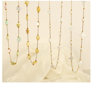 Vertical display of 18k gold plated chains with colorful star and cross shell pendants