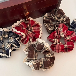 Set of 5 red and blue plaid scrunchies with elegant lace trim on a white background