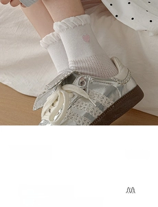 Close-up of white crew socks with pink heart embroidery made of premium combed cotton