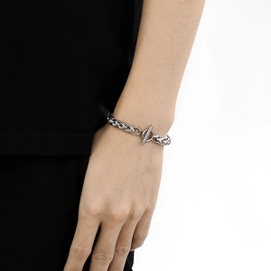 Detail of silver stainless steel chain bracelet with minimalist OT toggle clasp on wrist