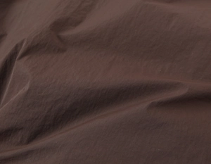 Close-up of brown padded jacket fabric with water-resistant micro-wrinkle texture