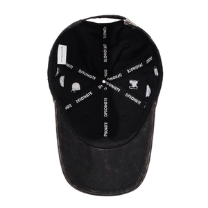 Interior detail of a vintage washed cotton baseball cap with letter embroidery and strap