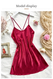 Detailed close-up of dark red satin slip dress with elegant criss-cross back straps