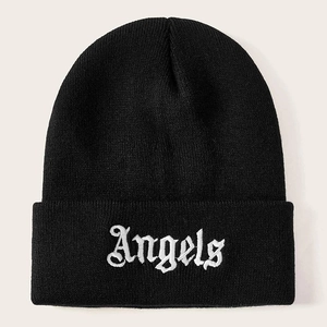 Close-up of black knitted beanie featuring white Gothic style Angels embroidery on cuff