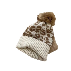 Women's leopard print knit beanie with fluffy faux fur pom pom and cuffed hem