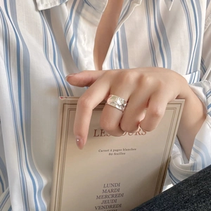 Close-up of minimalist 925 sterling silver irregular ring worn on model finger