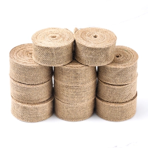 Stack of 8 rolls of natural jute burlap fabric with visible coarse weaving texture