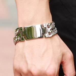 Macro detail of men's stainless steel double chain bracelet with rectangular plate