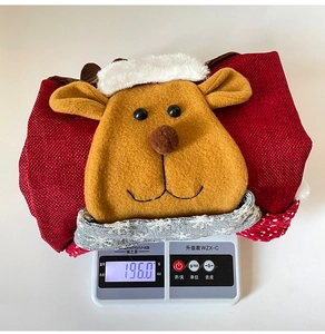 Weight display of Christmas reindeer chair cover showing 196.0g on a digital scale