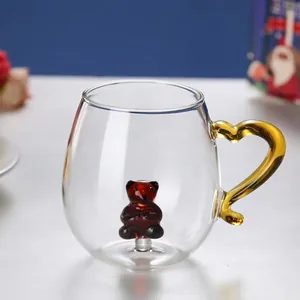 Detail of creative glass mug featuring a 3D glass bear and amber heart-shaped handle