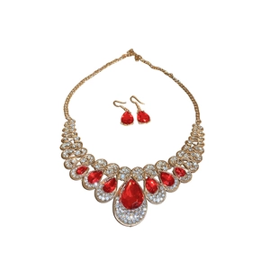 Elegant vintage jewelry set with gold metal and red teardrop gems and rhinestones