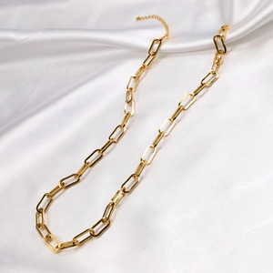 Gold paperclip chain link necklace in 18K gold plated stainless steel on white silk