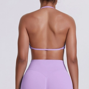 Back view of a purple seamless sports bra and leggings set with halter open back design