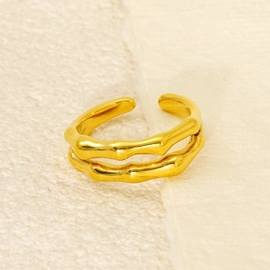 Macro shot of gold double-layered ring featuring detailed bamboo texture and polished finish