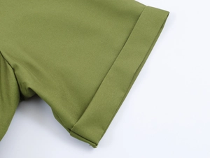 Detailed view of green short sleeve cuff showing high-quality woven fabric and stitching