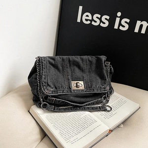 Retro denim tote bag with metal chain strap and twist lock on a minimalist background