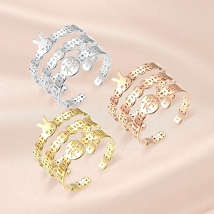 Detailed shot of triple-layer open rings with rabbit motif and Fortune charm on silk