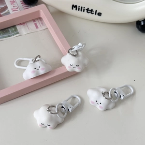 Close-up of cute cloud keychains with blushing faces and white metal lobster clasps