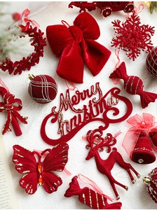 Detail of red flocked Christmas ornaments with gold glitter accents on white fleece