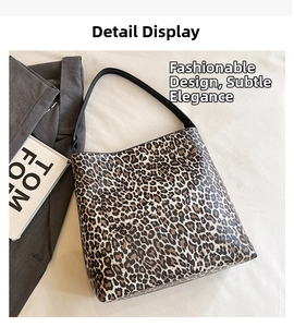 Detail shot of stylish leopard print faux leather tote bag with black shoulder straps