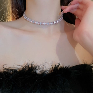 Close-up of sparkling pink and white zircon stones on a luxury tennis necklace