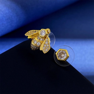 Elegant gold bee and hexagon stud earrings with sparkling cubic zirconia stones