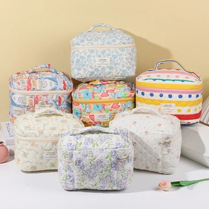Quilted floral makeup bags with handles in various patterns like heart and rainbow designs