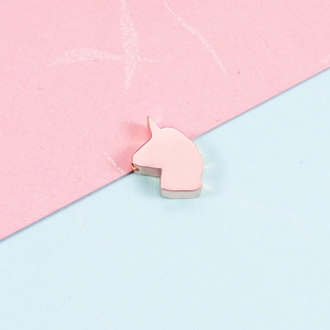 Close-up of polished rose gold unicorn silhouette pendant for DIY jewelry making