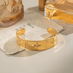 Polished 18K gold-plated open cuff bracelet with embossed clover floral texture