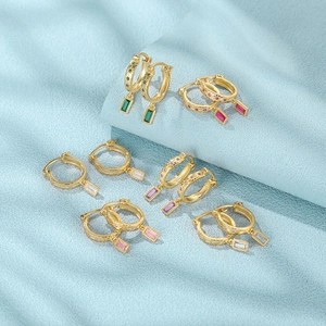 Detail of colorful rectangular zircon pendants on gold-plated silver hoop earrings