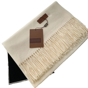 Thick cream cashmere-like scarf with long tassels and premium leather brand tag