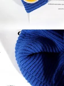 Detailed view of dark blue ribbed knit fabric and high-quality embroidery on the beanie