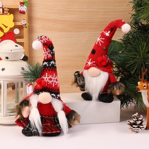 Christmas gnome dolls set with red plaid hat and snowflake pattern in festive setting
